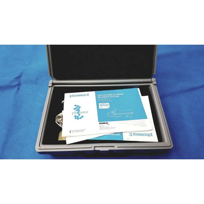 Gray hard-shell carrying case with phoresor ii pm700 iontophoretic drug delivery system manuals and cables inside