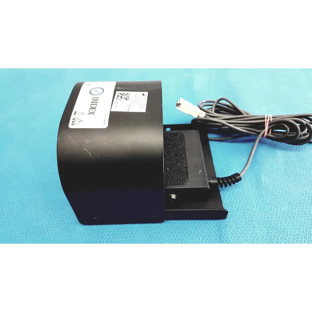 Black iridex laser foot switch footpedal with coiled power cord and textured grip for durable electric control