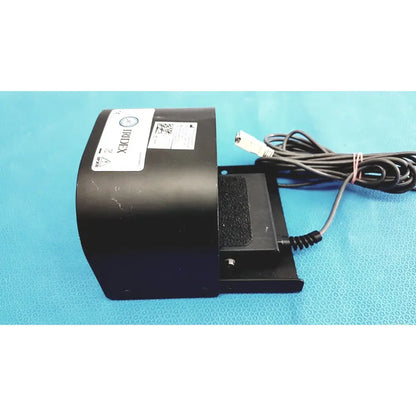 Black iridex laser foot switch footpedal with coiled power cord and textured grip for durable electric control