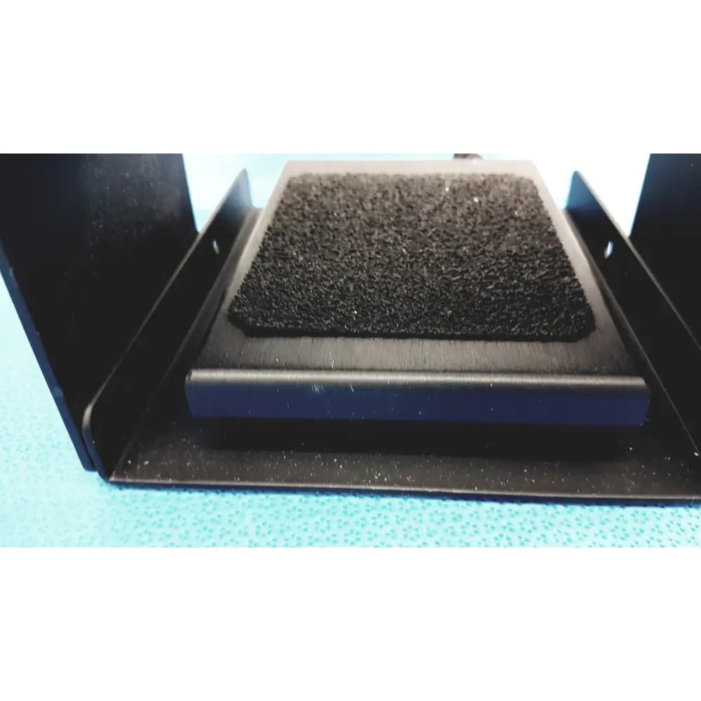 Black rectangular foam pad with textured surface on black metal frame in iridex laser foot switch footpedal for durable control
