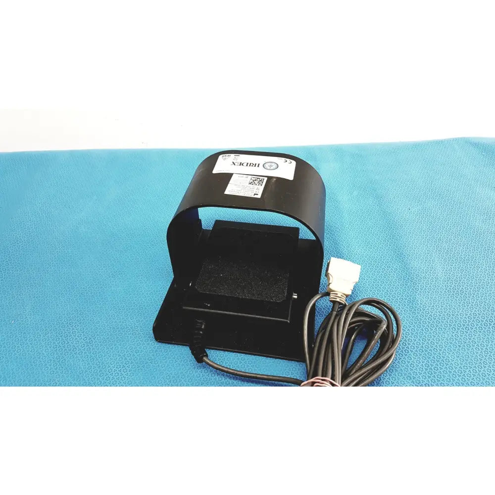Black plastic iridex laser foot switch footpedal with white label and coiled cable for durable electric control