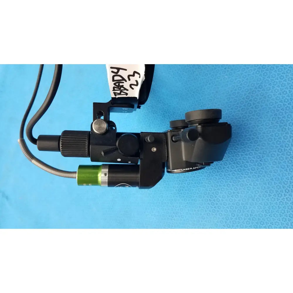 Black surgical microscope with green attachment labeled brady 23 used in iris medical laser indirect ophthalmoscope