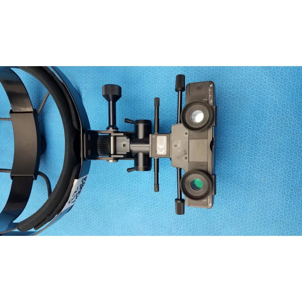 Black metal iris medical laser indirect ophthalmoscope with adjustable arms and dual clear and green-tinted lenses