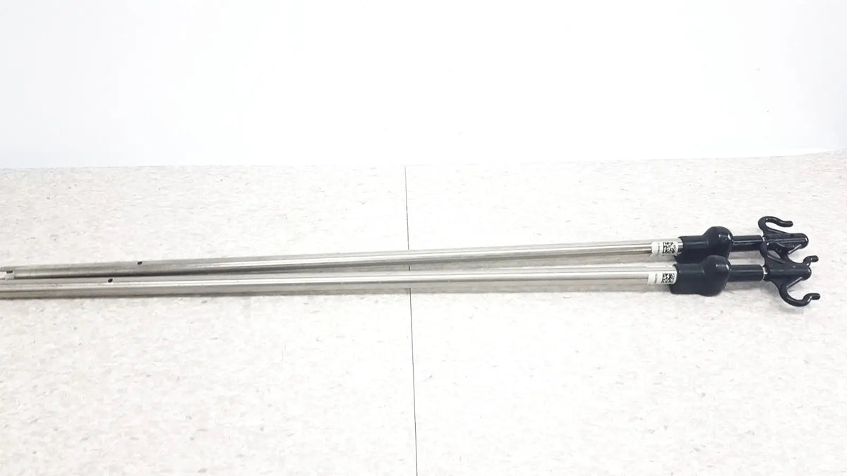 Two metallic iv pole poles with black plastic hooks compatible with hillrom p2217a for reuse medical purposes
