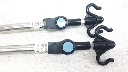 Black plastic hooks with silver metal rods and blue buttons on iv pole compatible with hillrom p2217a for reuse medical use