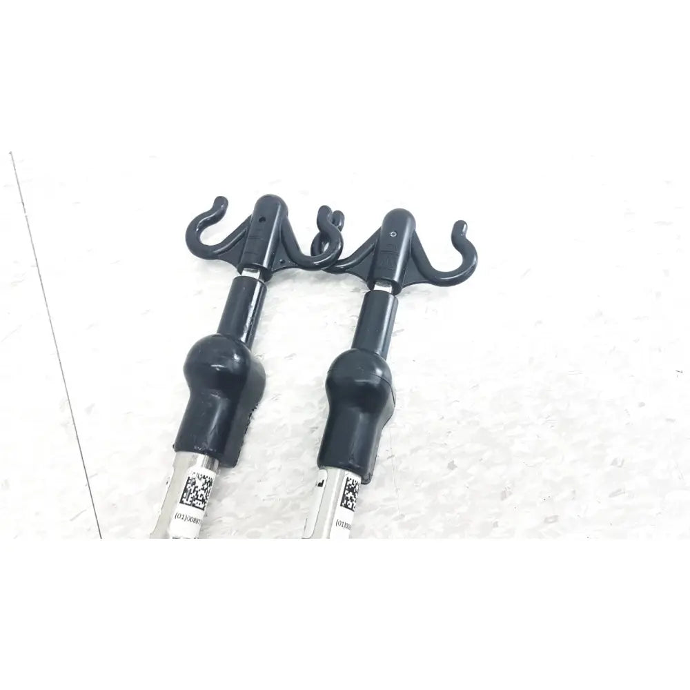 Black plastic hook attachments with matte finish and curved hooks for reuse medical iv pole compatible with hillrom p2217a p2217a