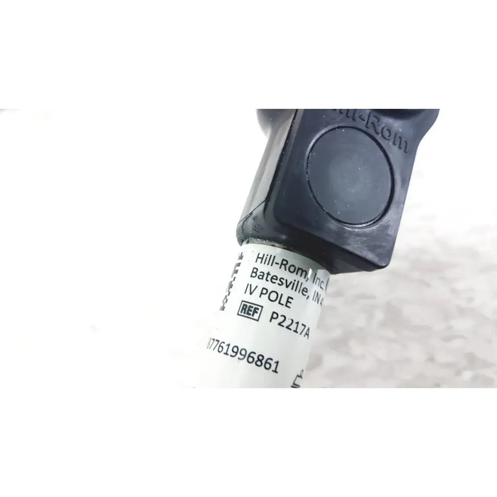 Black plastic iv pole compatible with hillrom p2217a featuring white label with product reference and reuse medical details