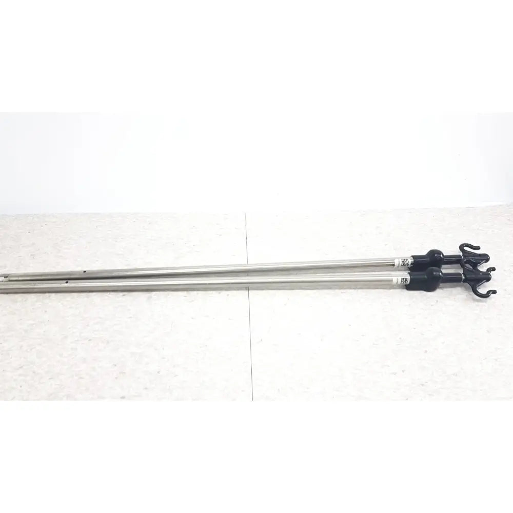 Two metallic iv pole poles with black plastic hooks compatible with hillrom p2217a for reuse medical purposes