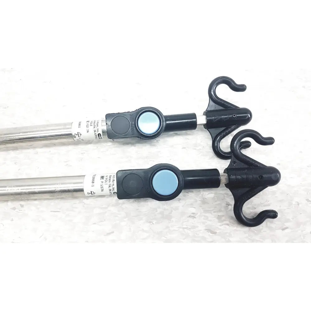 Black plastic hooks with silver metal rods and blue buttons on iv pole compatible with hillrom p2217a for reuse medical use