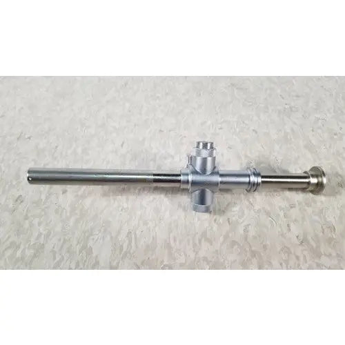 Silver-colored metal piston valve cannula with long cylindrical shaft and cross-shaped handle for surgical use