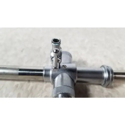 Jarit 600-440 piston valve cannula with pyramidal trocar in silver metallic surgical instrument with cross-shaped handle