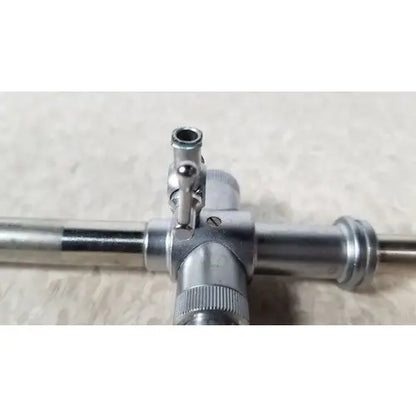 Jarit 600-440 piston valve cannula with pyramidal trocar in silver metallic surgical instrument with cross-shaped handle
