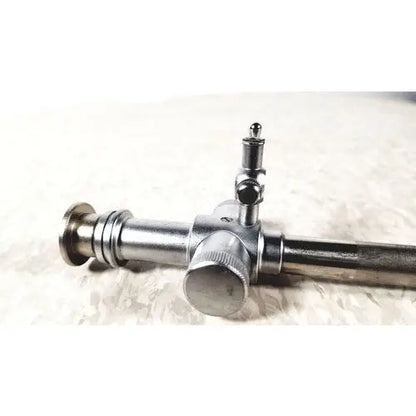 Jarit 600-440 silver metallic piston valve cannula with cylindrical body, threaded ends, and central adjustment knob