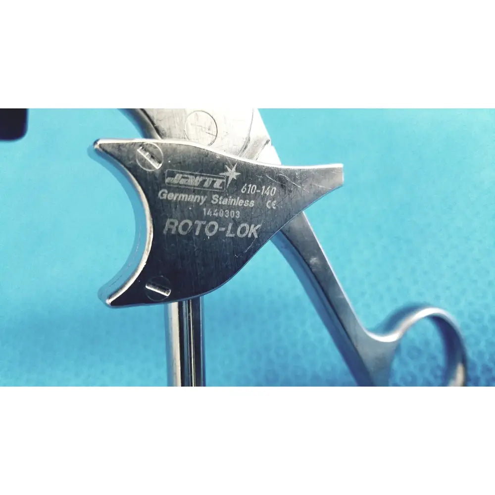 Silver stainless steel roto-lok surgical instrument jarit 610-140 with engraved markings and curved handle design