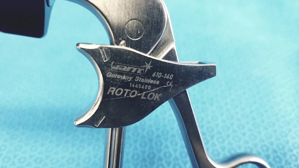 A sleek metallic jarit 610-140 stainless steel roto-lok surgical instrument with engraved hart germany markings