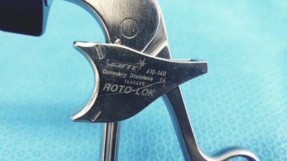 A sleek metallic jarit 610-140 stainless steel roto-lok surgical instrument with engraved hart germany markings