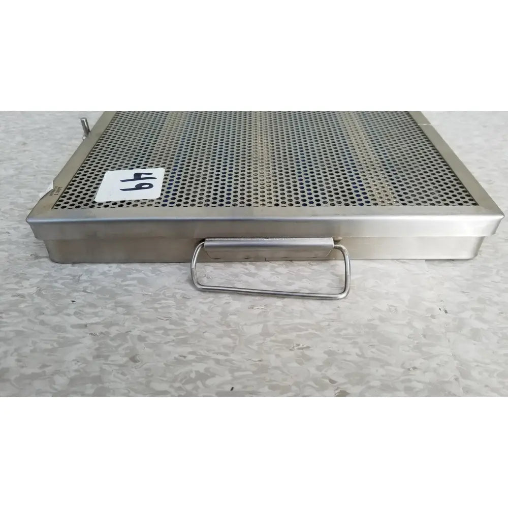 Jarir stainless steel 37988a perforated sterilization tray with rectangular handle and white 64 label on side
