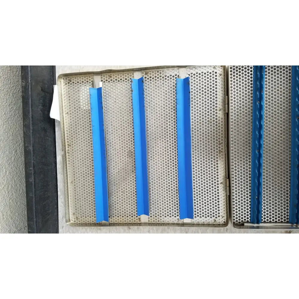 Blue plastic strips affixed to a perforated jarit stainless steel 37988a sterilization case grid panel