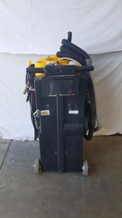 Black kaivac wet dry vacuum cleaning system with yellow accents and coiled hoses for industrial floor cleaning