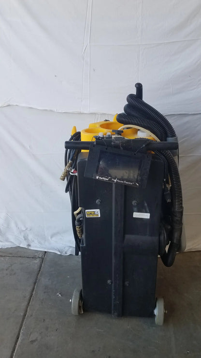 Black industrial floor cleaning wet dry vacuum machine with yellow accents and coiled black hoses by kaivac