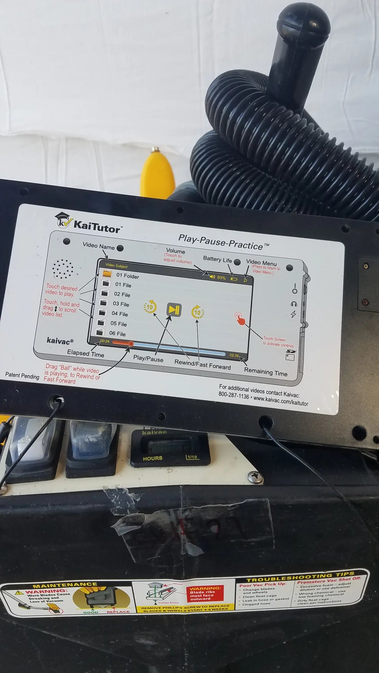 Black plastic control panel with white label showing kaitutor video playback on kaivac wet dry vacuum cleaning system