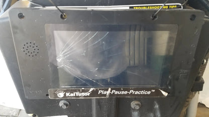 Black plastic kaitutor play-pause-practice device with cracked screen and speaker grille for kaivac wet dry vacuum system