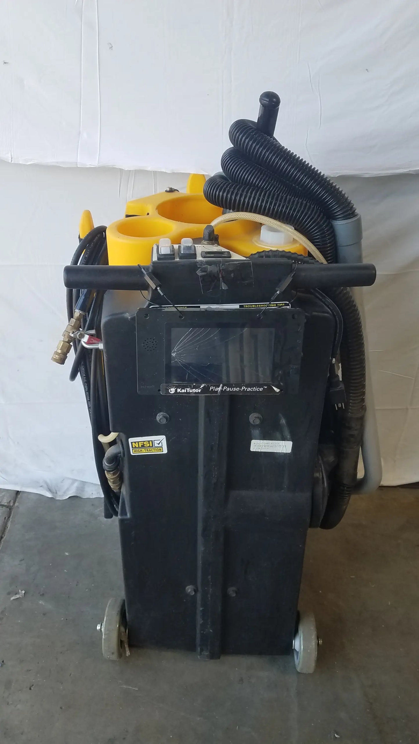 Black and yellow Kaivac wet dry vacuum cleaning system with digital display, hoses, and wheels for industrial use
