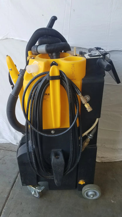 Kaivac yellow and black wet dry vacuum cleaning system with coiled hoses and wheels for industrial floor cleaning