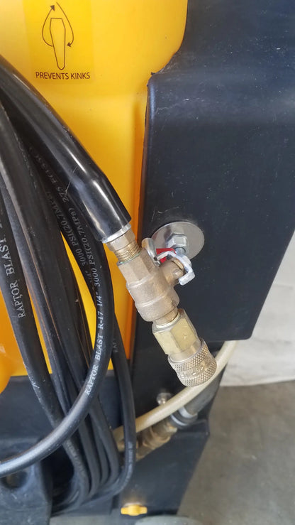 Yellow and black Kaivac wet dry vacuum cleaning system with coiled black hoses connected to brass fittings