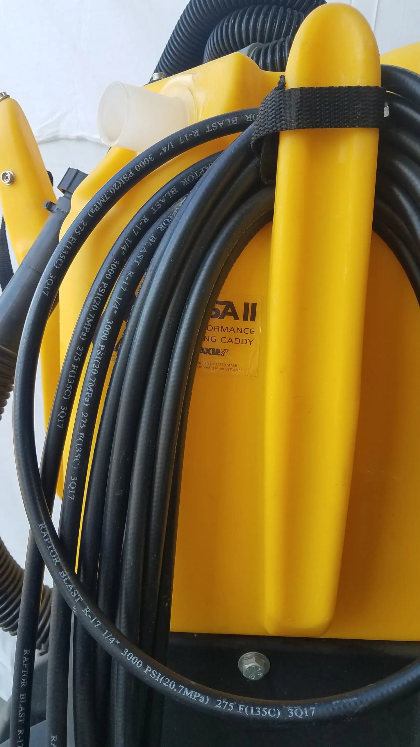 Yellow plastic blast cannon with black coiled hoses on the side for Kaivac wet dry vacuum cleaning system use