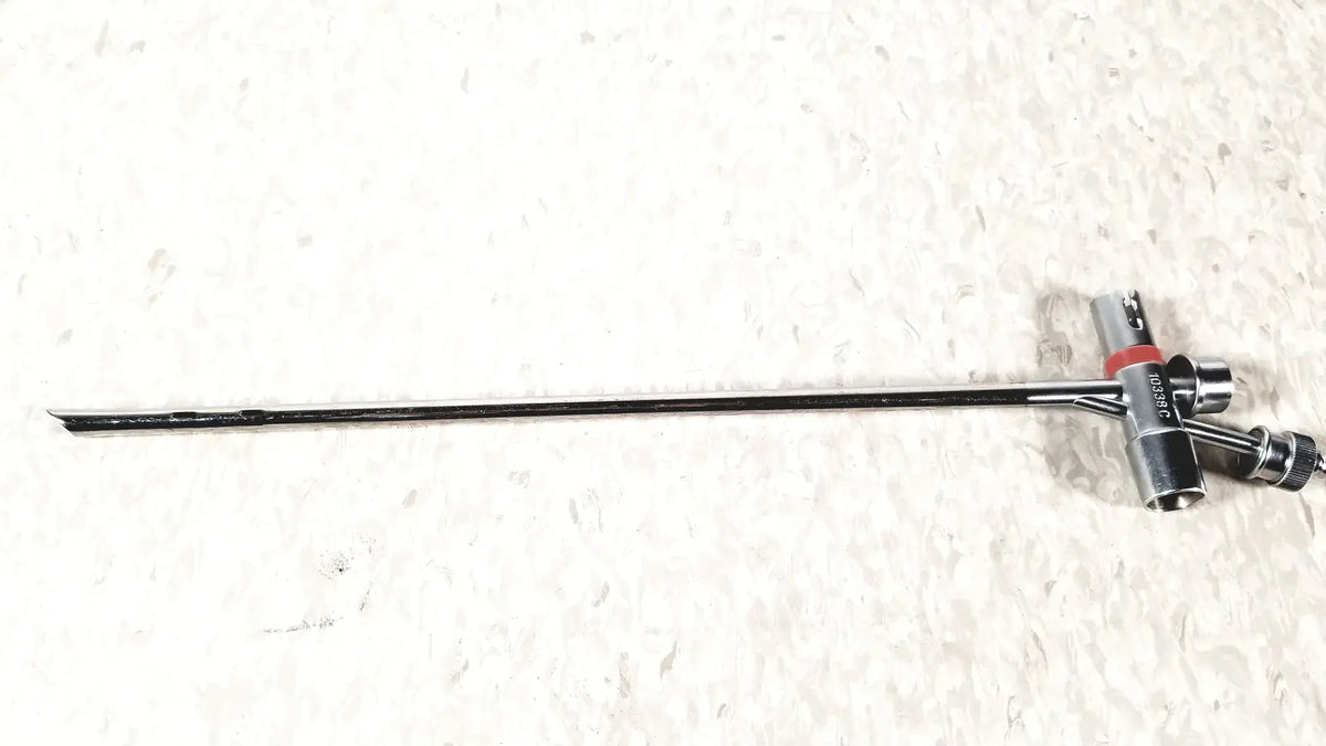 Silver-colored metal storz 10338c surgical bronchoscope scope sheath with long slender shaft and t-shaped handle with red accents