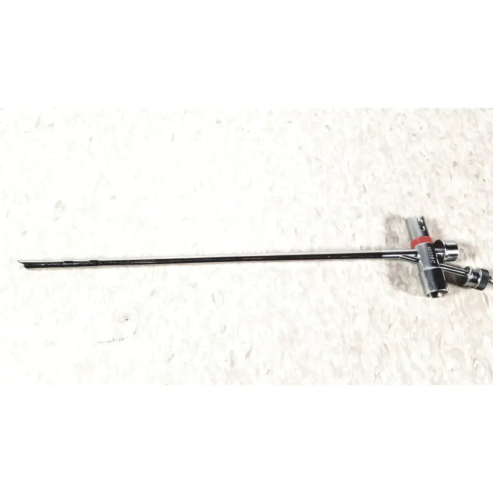Black metal storz 10338c surgical bronchoscope sheath with long slender shaft and red-accented complex handle assembly