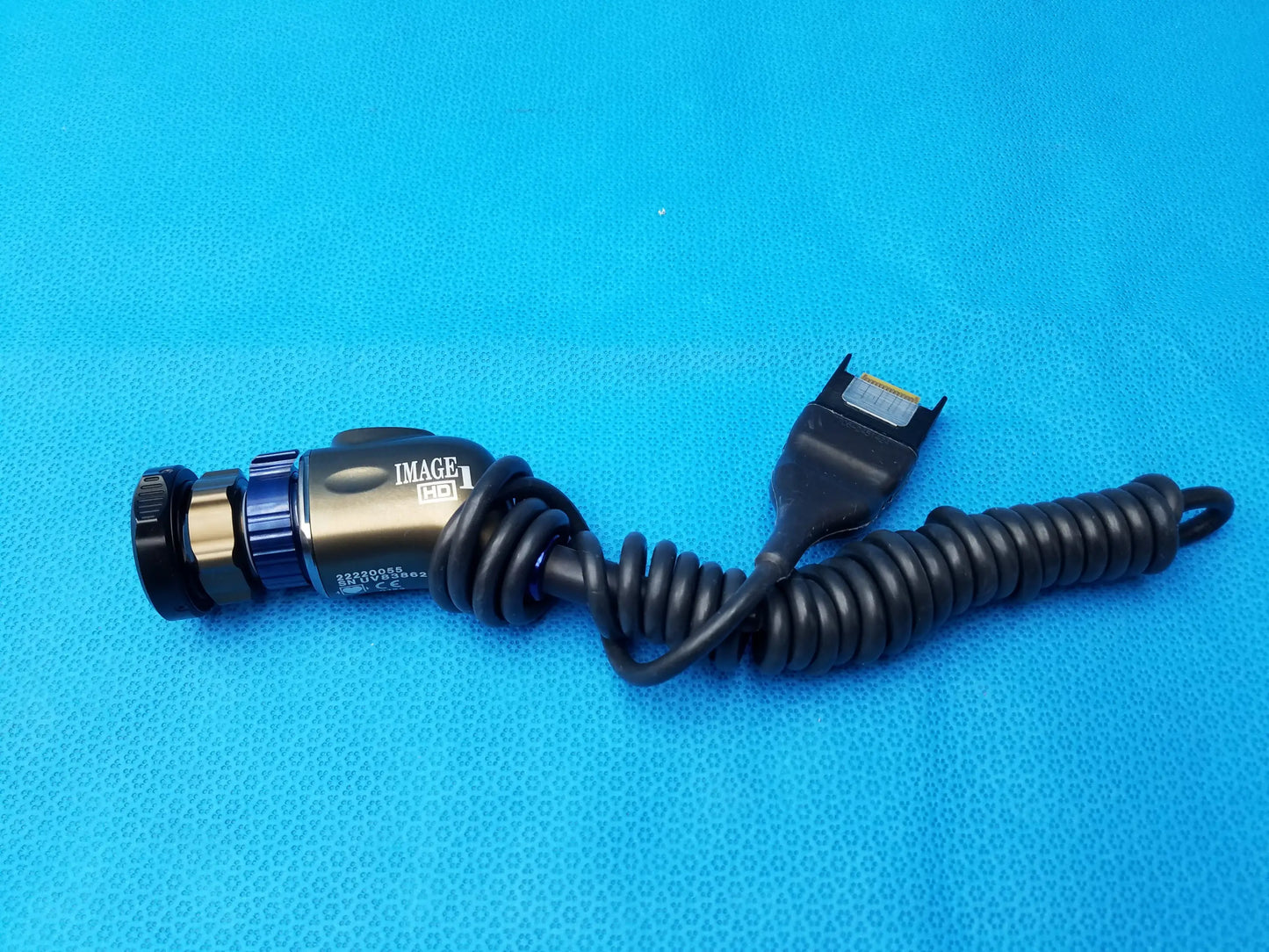 Black coiled cable with metallic gold and blue Karl Storz image 1 camera head precision imaging component at one end