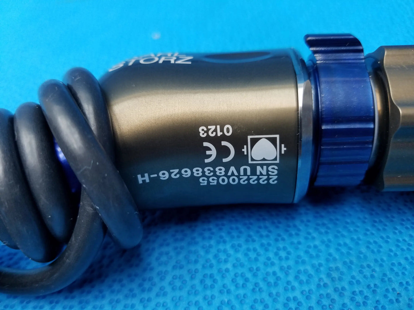Black coiled cable attached to a metallic karl storz precision imaging component camera head with serial number and ce marking