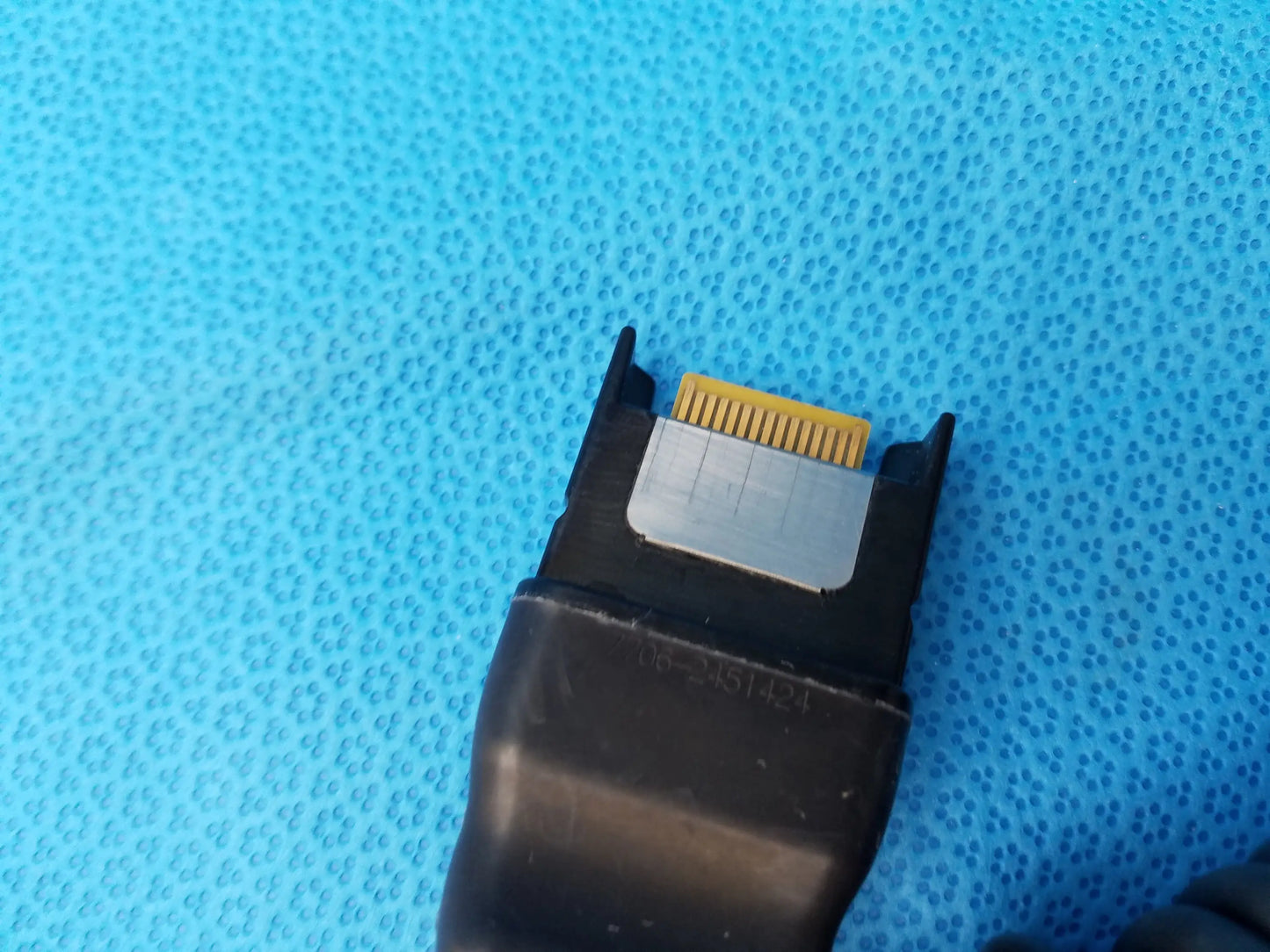 Black plastic karl storz camera head connector with gold pin array and silver plate precision imaging component back view