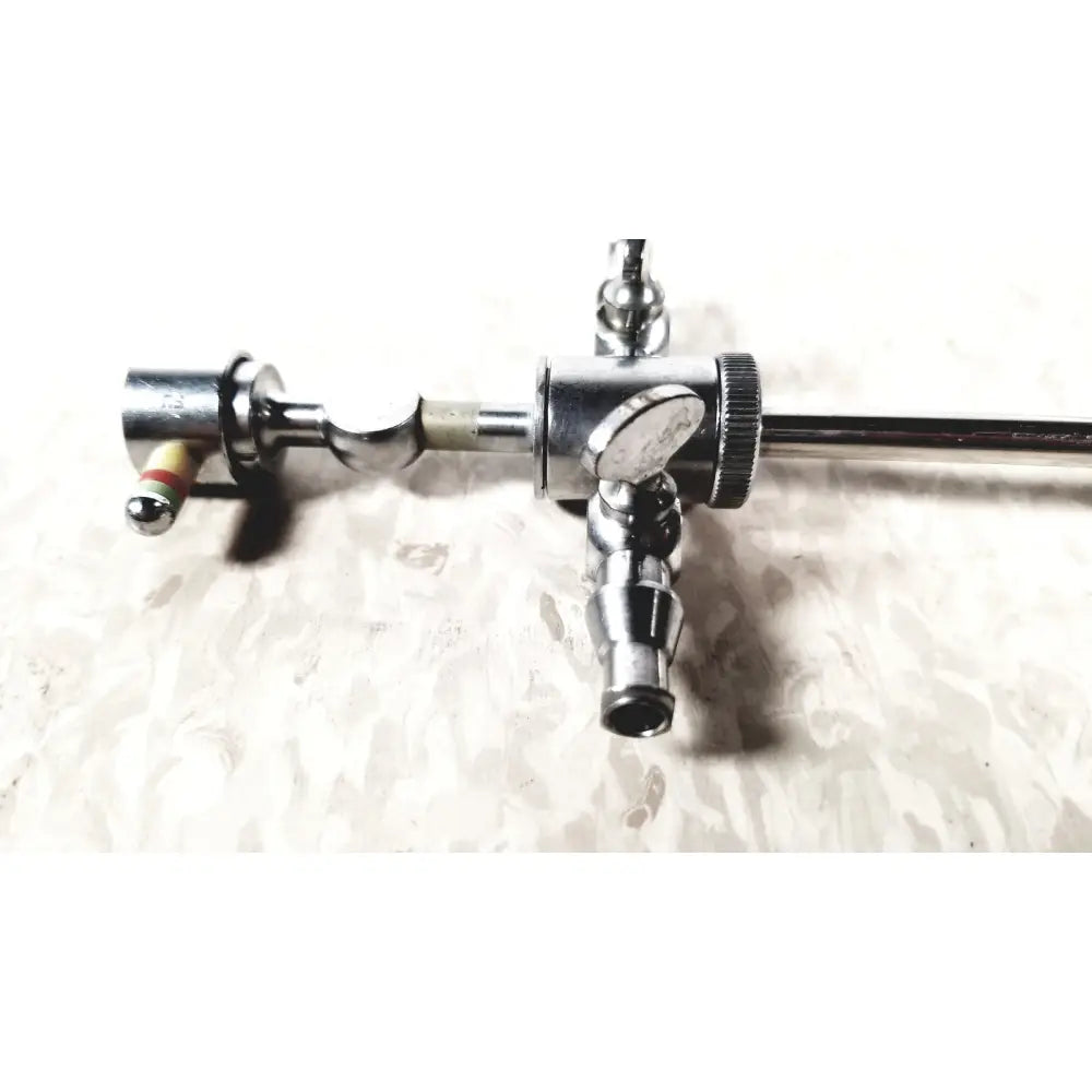 Silver metallic storz 28124cr cannula with dual rotating stopcocks textured grip and multiple connection ports
