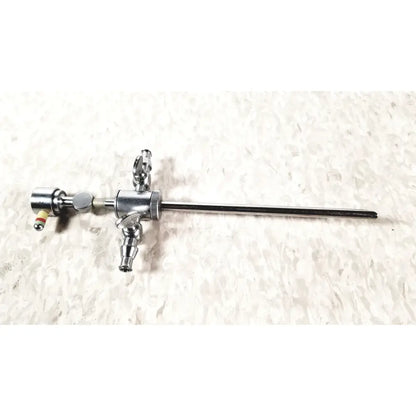 Silver-colored metal storz 28124cr cannula with dual rotating stopcocks and articulated joints surgical sheath
