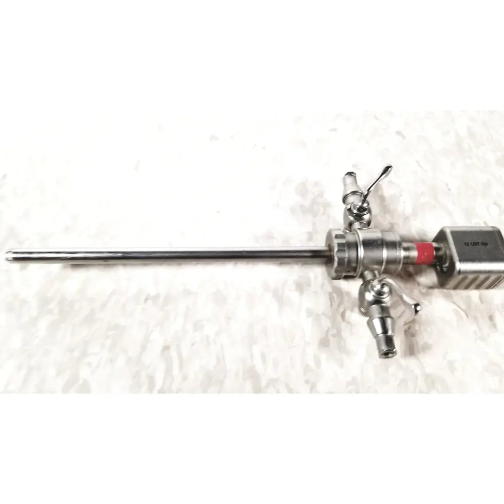 Silver karl storz diagnostic arthro sheath with long slender metallic shaft and multiple control knobs on handle
