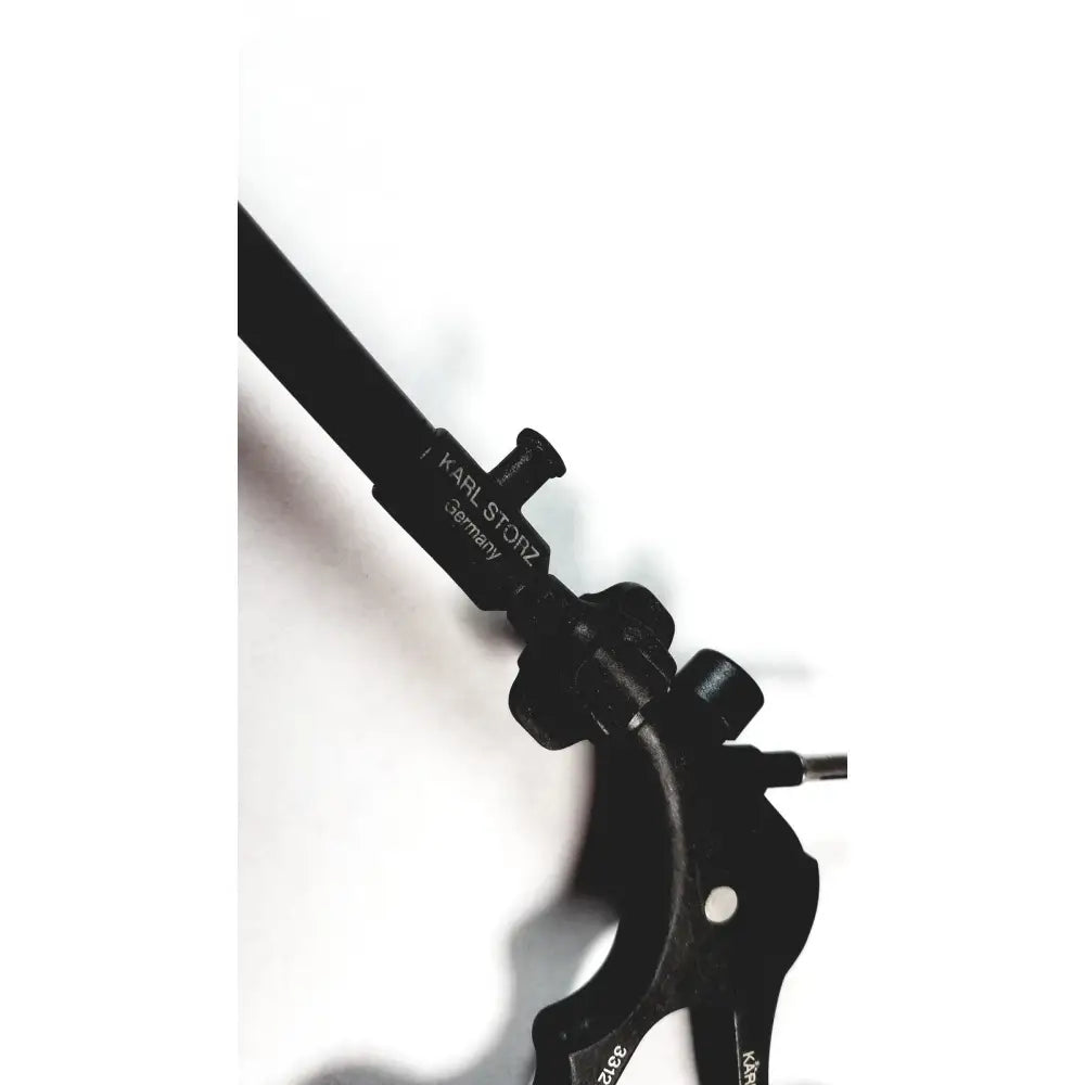 Black metal karl storz clickline handle with tube for laparoscopic instruments engraved with karl storz germany