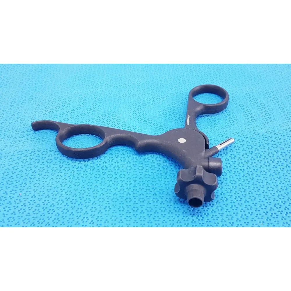 Black karl storz clickline monopolar plastic laparoscopic instrument with ergonomic handles and central adjustment mechanism