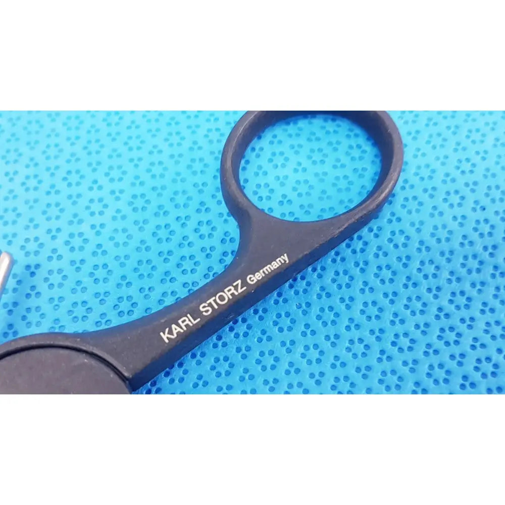 Black surgical scissors with karl storz germany engraved on black clickline monopolar plastic handle