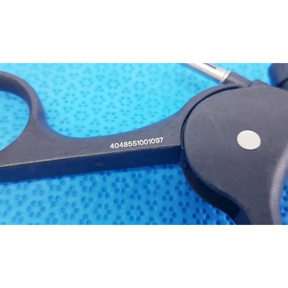 Black plastic-handled karl storz clickline monopolar plastic laparoscopic forceps with metallic tip and engraved serial number