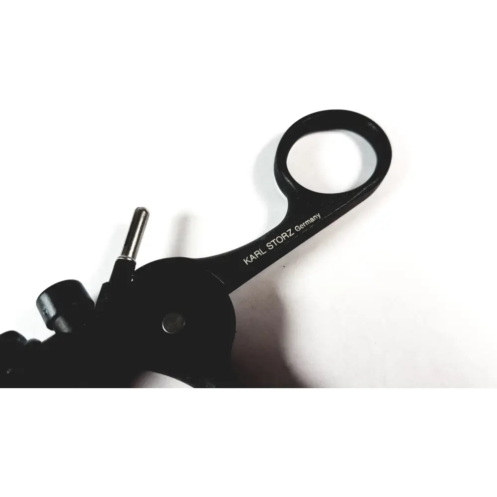 Black karl storz clickline plastic handle endoscopic surgical instrument with loop handle and metallic adjustment knob