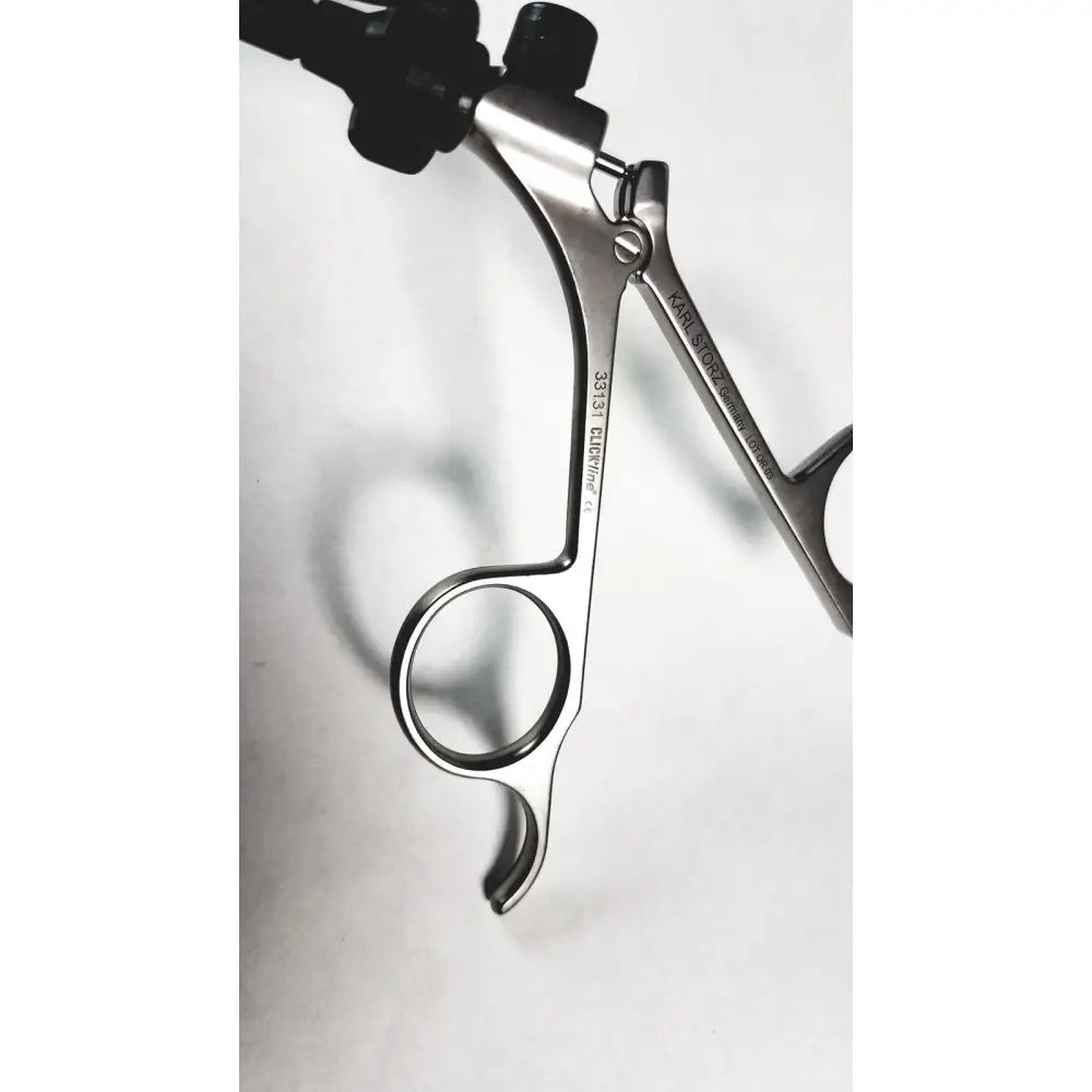 Silver karl storz shaft laparoscopic grasper with black ergonomic handles and engraved branding surgical instrument