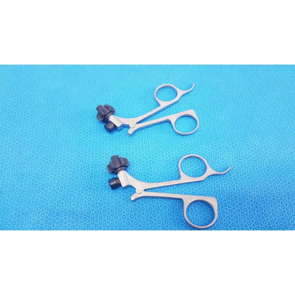 Silver surgical forceps with black textured clickline handle and curved tip for laparoscopic surgical use by karl storz