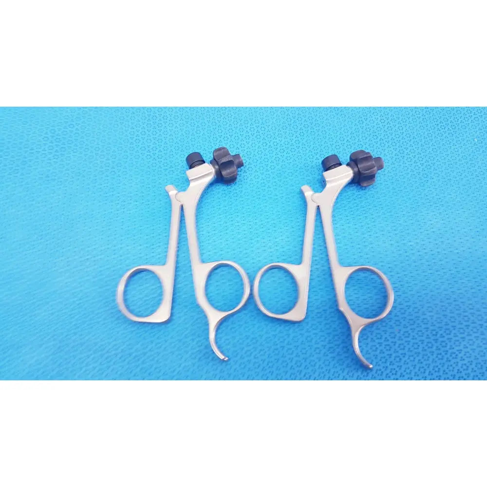 Silver surgical forceps with black textured knobs featuring karl storz clickline handle for laparoscopic surgical use lot of 2