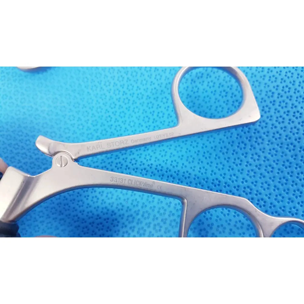 Silver laparoscopic surgical forceps with polished metal finish and ergonomic clickline handle by karl storz lot of 2