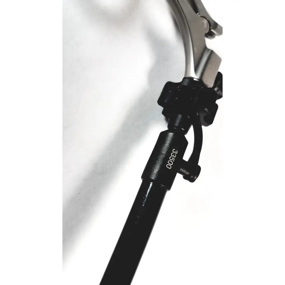 Black karl storz clickline handle with metallic articulated head and engraved serial number 38500 for shaft laparoscopic surgical use