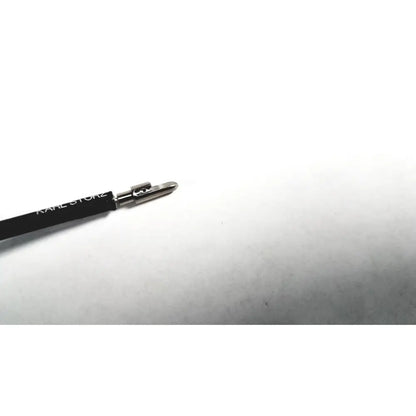 Black karl lagerfeld eyeliner pencil with silver metallic tip and logo next to karl storz clickline metal handle laparoscopic tool