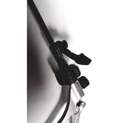 Black plastic bicycle cable housing with metal clamp and adjustment on karl storz clickline metal handle laparoscopic tool